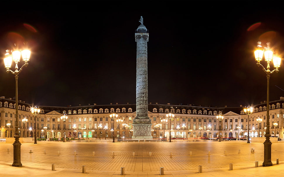 concrete monument surrounded by infrastructure on nigh time HD wallpaper